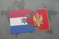 puzzle with the national flag of netherlands and montenegro on a world map background. Royalty Free Stock Photo