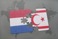 puzzle with the national flag of netherlands and northern cyprus on a world map background. Royalty Free Stock Photo