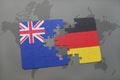 puzzle with the national flag of new zealand and germany on a world map background Royalty Free Stock Photo