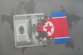 puzzle with the national flag of north korea and dollar banknote on a world map background. Royalty Free Stock Photo