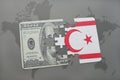 puzzle with the national flag of northern cyprus and dollar banknote on a world map background. Royalty Free Stock Photo