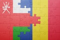 puzzle with the national flag of oman and romania