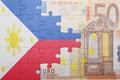 Puzzle with the national flag of philippines and euro banknote