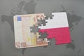 puzzle with the national flag of poland and euro banknote on a world map background. Royalty Free Stock Photo