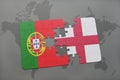 puzzle with the national flag of portugal and england on a world map background.