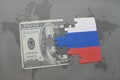 puzzle with the national flag of russia and dollar banknote on a world map background. Royalty Free Stock Photo