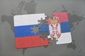 puzzle with the national flag of russia and serbia on a world map background. Royalty Free Stock Photo