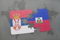 puzzle with the national flag of serbia and haiti on a world map Royalty Free Stock Photo