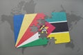 puzzle with the national flag of seychelles and mozambique on a world map