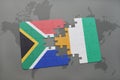 puzzle with the national flag of south africa and cote divoire on a world map.
