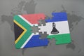 puzzle with the national flag of south africa and lesotho on a world map. Royalty Free Stock Photo
