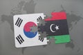 puzzle with the national flag of south korea and libya on a world map background.