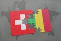 puzzle with the national flag of switzerland and mali on a world map background.