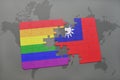 puzzle with the national flag of taiwan and gay rainbow flag on a world map background. Royalty Free Stock Photo