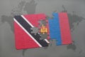 puzzle with the national flag of trinidad and tobago and mongolia on a world map