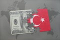 puzzle with the national flag of turkey and dollar banknote on a world map background. Royalty Free Stock Photo