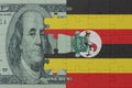 puzzle with the national flag of uganda and dollar money banknote. macro.concept