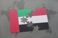 puzzle with the national flag of united arab emirates and yemen on a world map background.