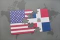 puzzle with the national flag of united states of america and dominican republic on a world map background Royalty Free Stock Photo