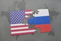 Puzzle with the national flag of united states of america and russia on a world map background Royalty Free Stock Photo