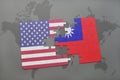 puzzle with the national flag of united states of america and taiwan on a world map background Royalty Free Stock Photo