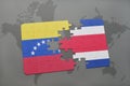 puzzle with the national flag of venezuela and costa rica on a world map background. Royalty Free Stock Photo