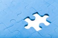 Puzzle piece missing from a blue jigsaw puzzle in a close-up view Royalty Free Stock Photo