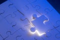 Puzzle pieces with a beam of light glowing Royalty Free Stock Photo