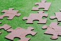 Puzzle pieces on green background Closeup of wooden puzzle pieces Royalty Free Stock Photo