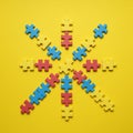 Puzzle pieces in red, blue, and yellow are arranged in a radial pattern on a yellow Royalty Free Stock Photo
