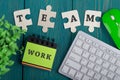 Puzzle pieces with text & x22;team& x22;, note pad with word & x22;work& x22;, computer keyboard Royalty Free Stock Photo