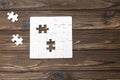 Puzzle pieces on a wooden background. missing parts Royalty Free Stock Photo