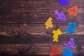 Puzzle pieces on wooden background, top view, flat lay. Autism Spectrum Disorder ASD. Autism awareness. Concept of autism word