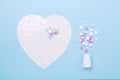 Puzzle in shape of heart white and pink pills on blue background Jigsaw Concept treatment of heart disease pills Royalty Free Stock Photo