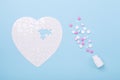 Puzzle in shape of heart white and pink pills on blue background Jigsaw Concept treatment of heart disease pills Royalty Free Stock Photo