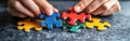 Puzzle Solving Closeup with Copy Space: Hands Concentrating on Aligning Colorful Pieces in Chaotic Arrangement, Ideal fo