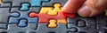 Puzzle Solving Closeup with Copy Space: Hands Concentrating on Aligning Colorful Pieces in Chaotic Arrangement, Ideal fo