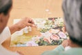 Puzzle on table, entertainment and senior couple in home for bonding, fun activity and relax together. Retirement Royalty Free Stock Photo