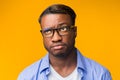 Puzzled African American Man Thinking About Something Standing, Orange Background Royalty Free Stock Photo