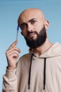 Puzzled arab man in thoughts holding pen Royalty Free Stock Photo