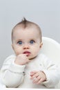 Puzzled Baby in Highchair