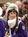 puzzled baby majorette wrapped up against rain at Carnival parade, Stuttgart