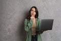 Puzzled beautiful brunette girl thinking and using laptop Royalty Free Stock Photo