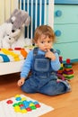 Puzzled boy playing with mosaic Royalty Free Stock Photo