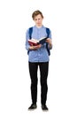 Puzzled boy teenager, student reader looking amazed in a book. Confused adolescent reading a textbook isolated over white Royalty Free Stock Photo