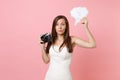 Puzzled bride woman in wedding dress hold retro vintage photo camera, Say cloud speech bubble with lightbulb choosing