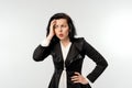 Puzzled businesswoman in black formal jacket white shirt looking dejected, standing over white background. Small business owners,