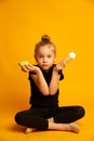 Puzzled little dancer choosing between pear and ice cream Royalty Free Stock Photo