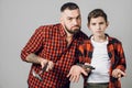 Puzzled man and his son having some problems in reparing something Royalty Free Stock Photo