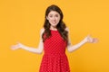 Puzzled perplexed young brunette woman girl in red summer dress posing isolated on yellow background studio portrait